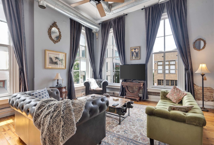 Living area with hardwood / wood-style flooring and a ceiling fan
