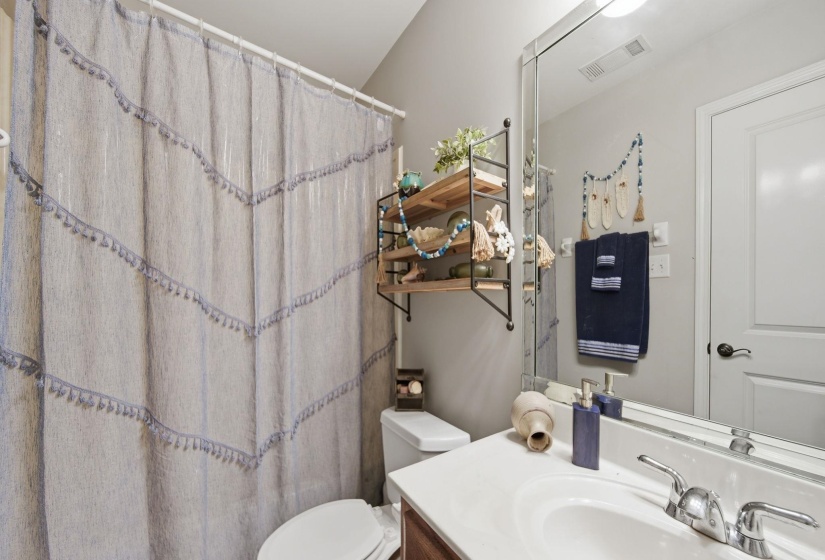 Bathroom featuring vanity and a shower with shower curtain