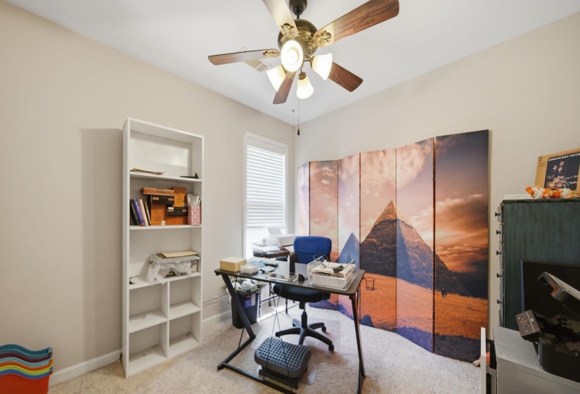 Office space with a ceiling fan and light colored carpet