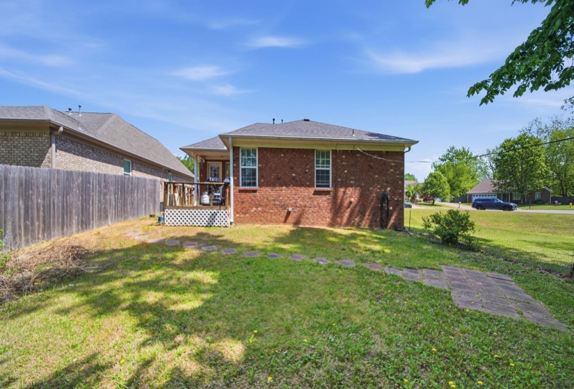 Rear view of house with a wooden deck and brick siding