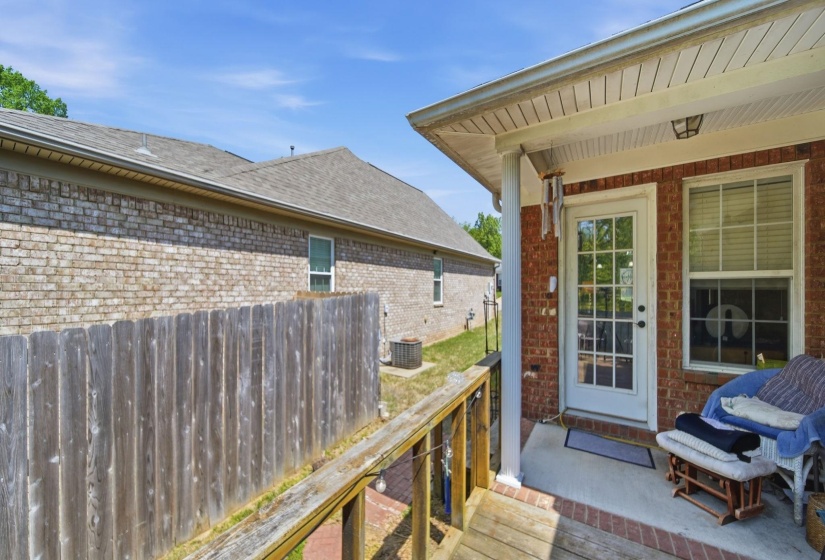 View of exterior entry with a shingled roof and brick siding