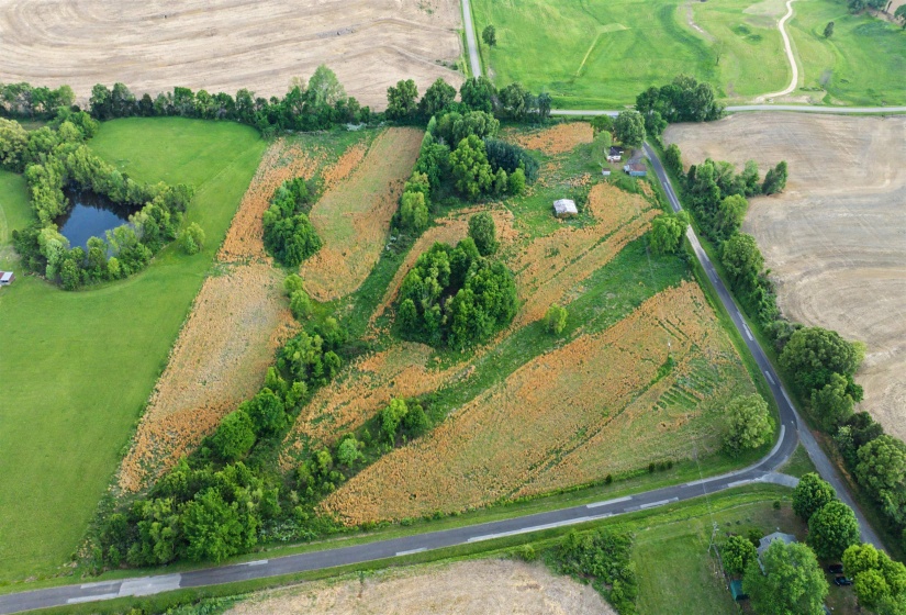 Aerial view of property and surrounding area with rural landscape and a nearby body of water