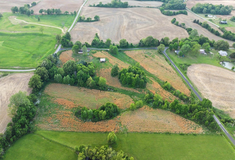 Aerial view of property's location featuring rural landscape and extensive farmland