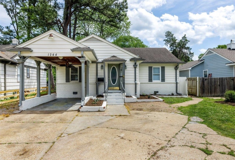 Bungalow-style home featuring brick siding, concrete driveway, an attached carport, and roof with shingles