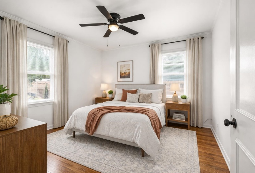 Bedroom with hardwood / wood-style floors, a ceiling fan, and ornamental molding