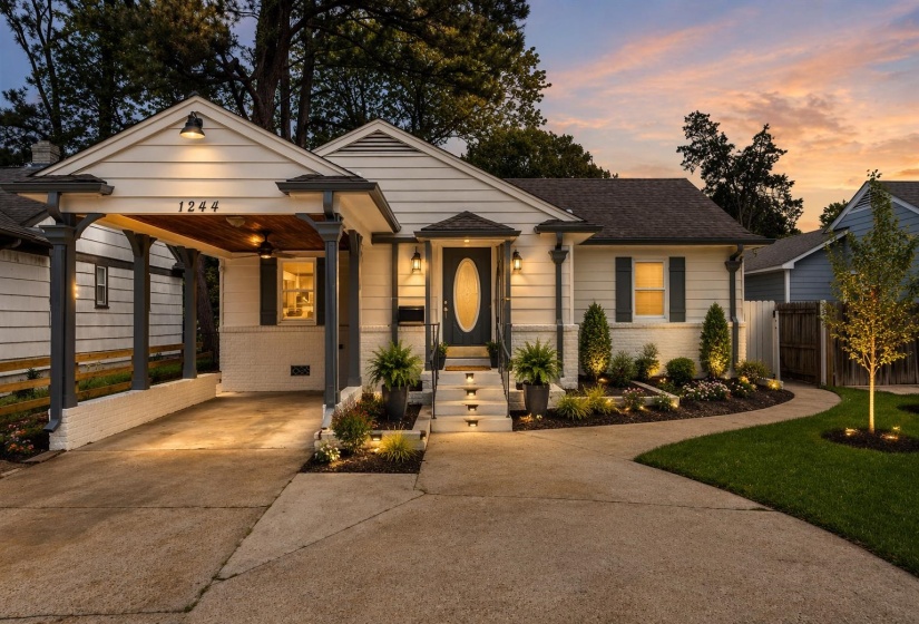 Bungalow-style home featuring brick siding, concrete driveway, an attached carport, and a shingled roof