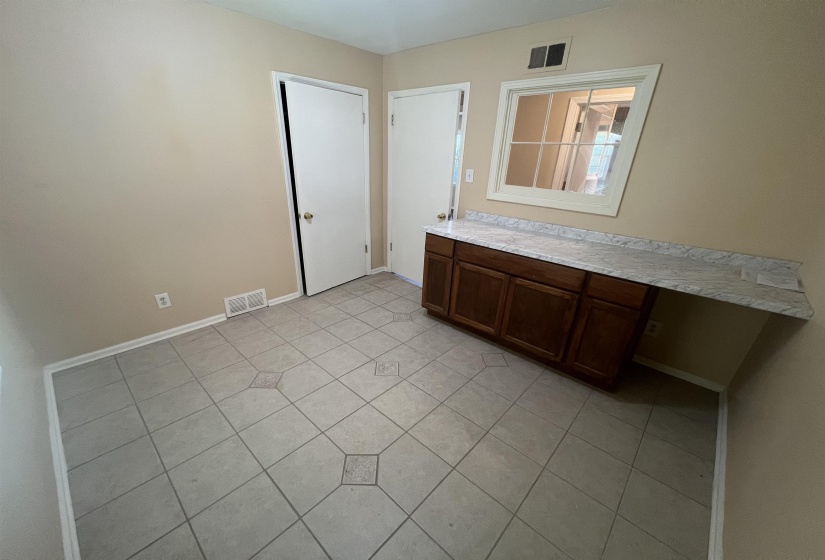 Use as a bdrm or large laundry room. Counter top/cabinets can be removed.