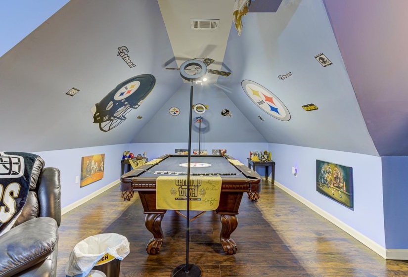 Recreation room with dark wood-type flooring and billiards table