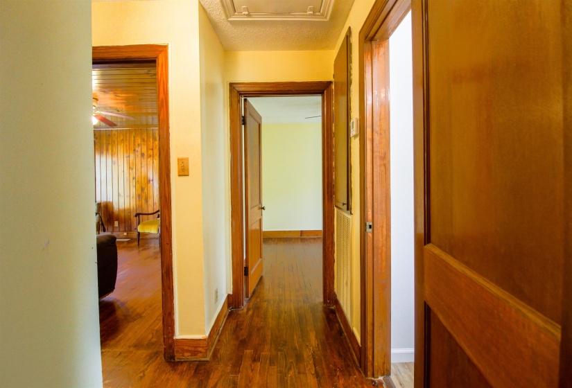 Corridor with dark wood finished floors and baseboards