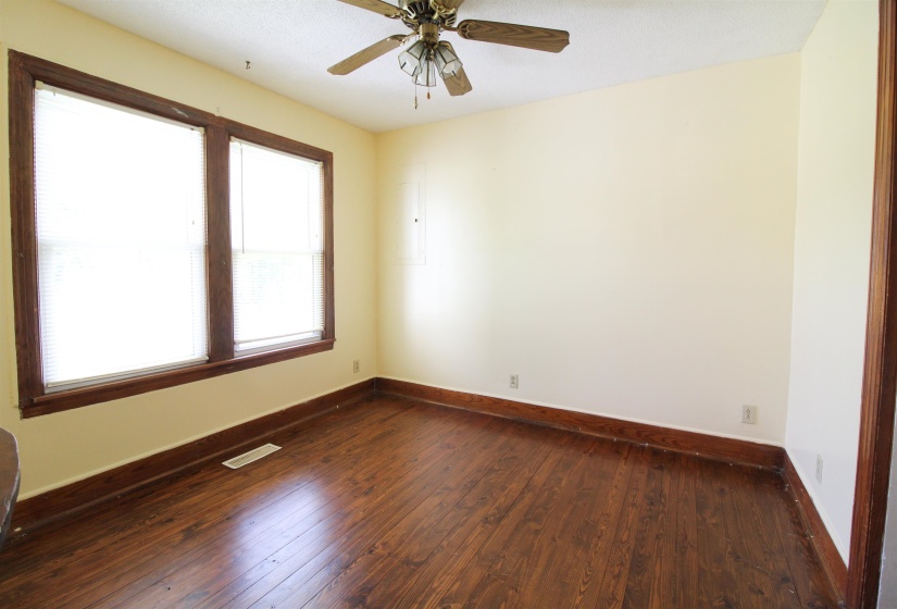 Formal Dining Room featuring dark wood finished floors, ceiling fan, and a textured ceiling