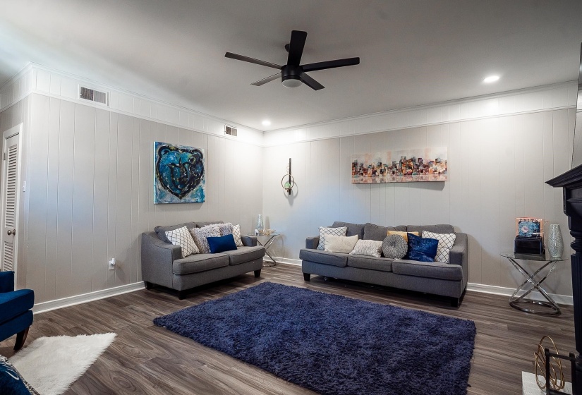 Living area with dark wood-type flooring, ceiling fan, and recessed lighting