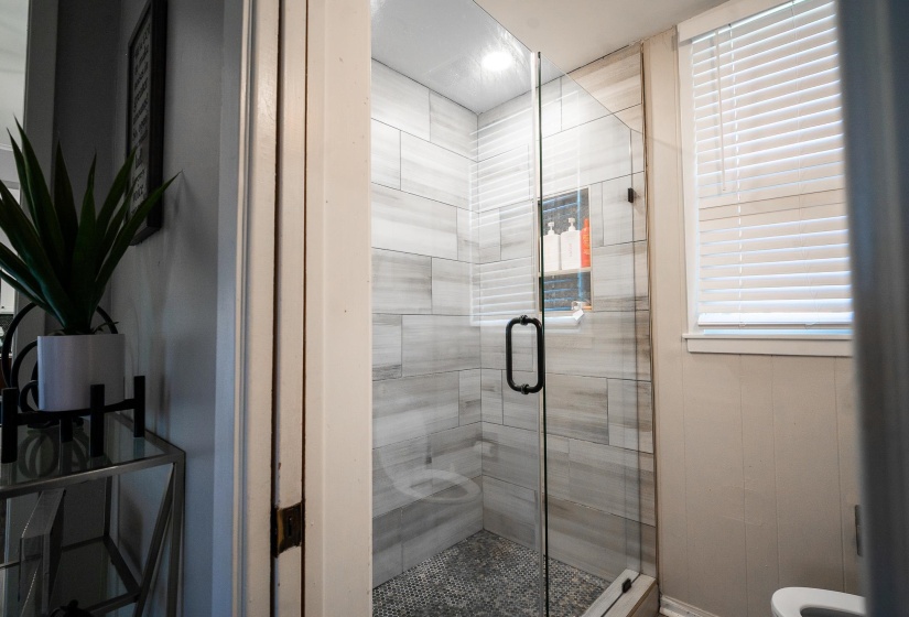 Full bathroom featuring a shower stall
