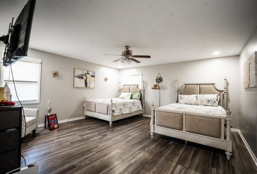 Bedroom with ceiling fan, dark wood-type flooring, and recessed lighting