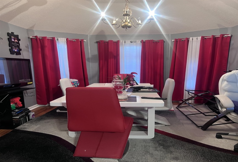 Dining space with a textured ceiling and a chandelier