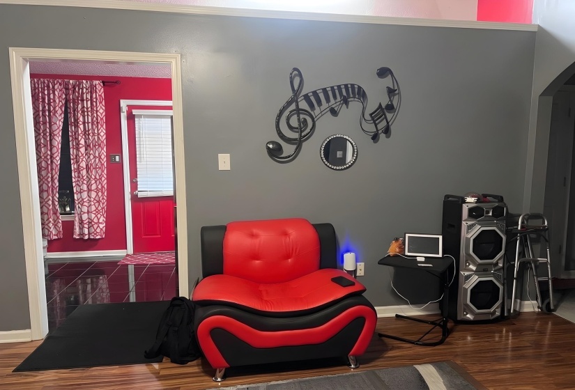 Living area with dark wood-style floors and arched walkways