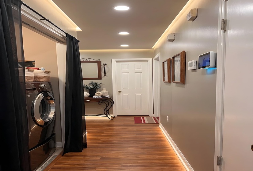 Hallway featuring recessed lighting, dark wood finished floors, and washer / clothes dryer