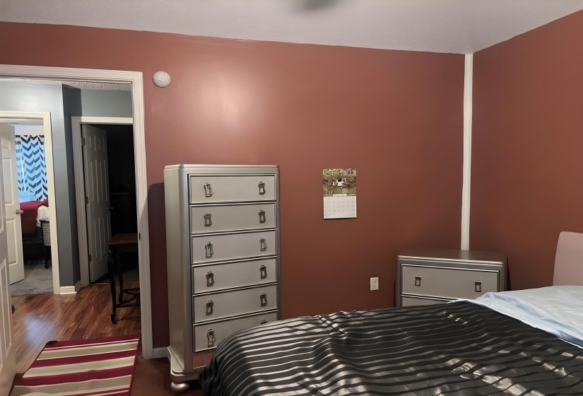 Bedroom featuring baseboards and dark wood-style floors