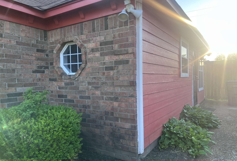 View of property exterior featuring brick siding
