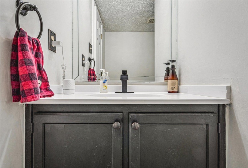 Bathroom with vanity and a textured ceiling
