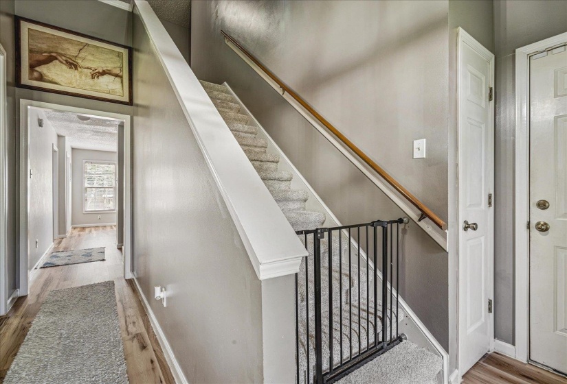 Stairs featuring wood finished floors and baseboards