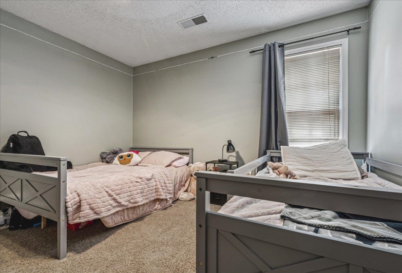 Bedroom with carpet flooring and a textured ceiling
