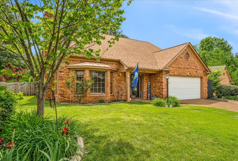 View of front of property with brick siding, a shingled roof, a garage, and concrete driveway