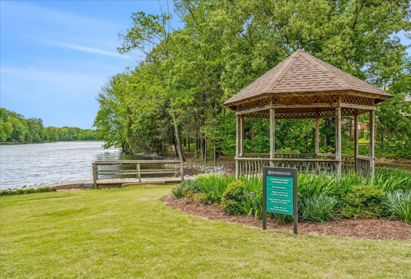 Surrounding community with a gazebo and a water view