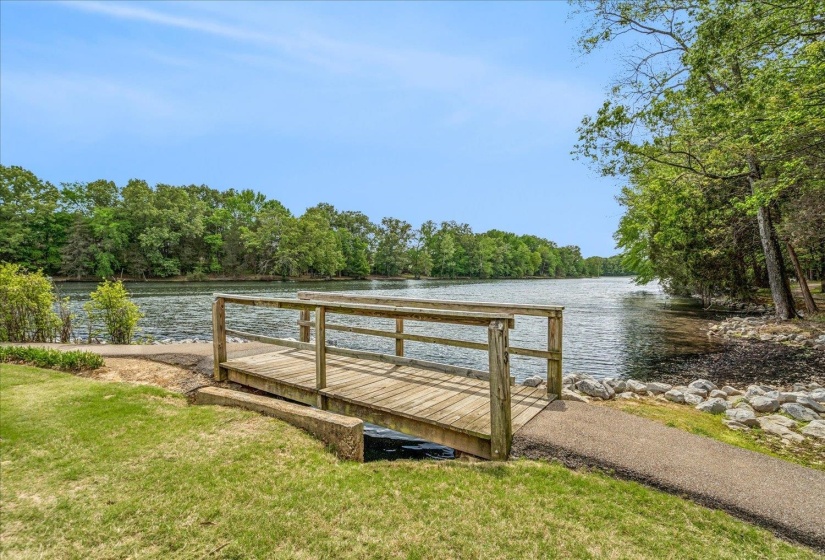 Dock featuring a water view and a yard