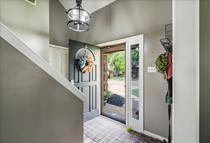 Entrance foyer with suspended lighting and baseboards