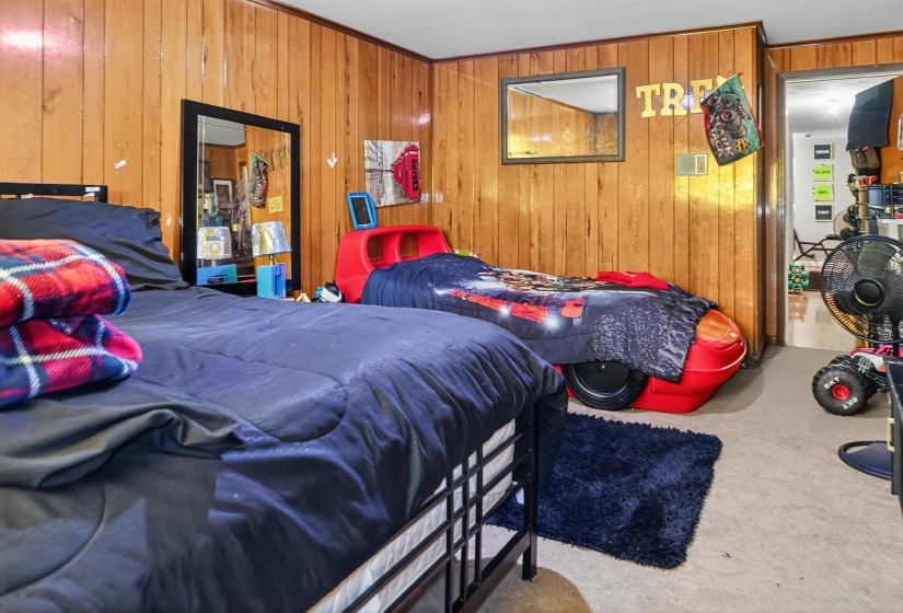 Bedroom featuring wood walls