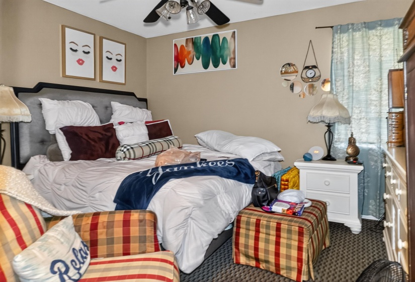 Bedroom featuring ceiling fan and carpet flooring