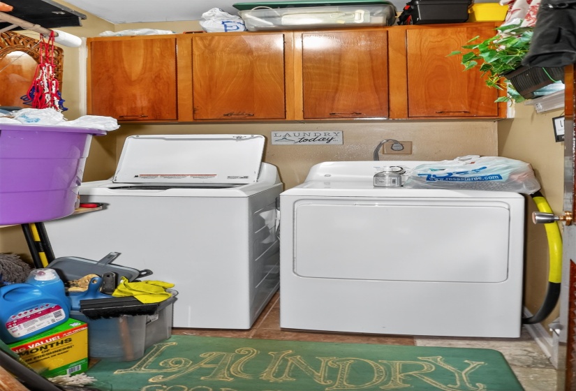 Laundry area featuring cabinet space and washer and clothes dryer