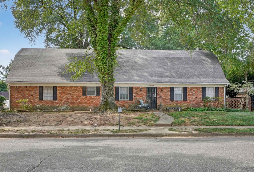 Colonial inspired home featuring a shingled roof, brick siding, and a gambrel roof