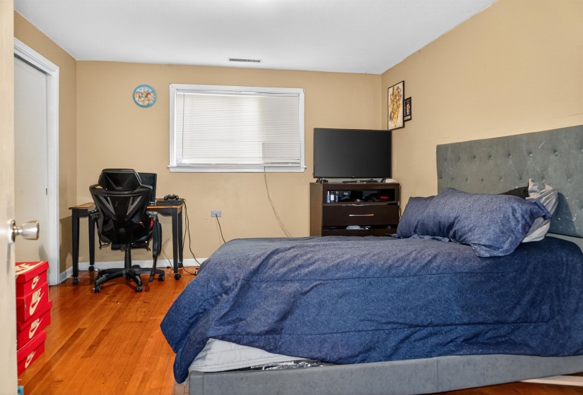 Bedroom with light wood-type flooring and a desk