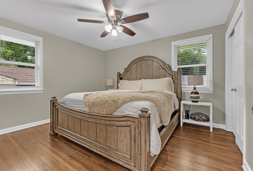 Bedroom featuring a ceiling fan, dark wood-type flooring, and a closet