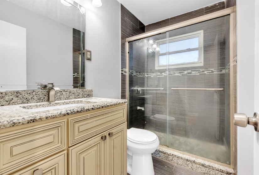 Bathroom with vanity and a shower stall