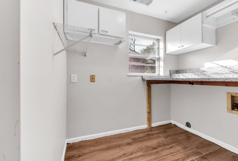 Laundry area featuring  finished floors, cabinet space, and washer/dryer hookup