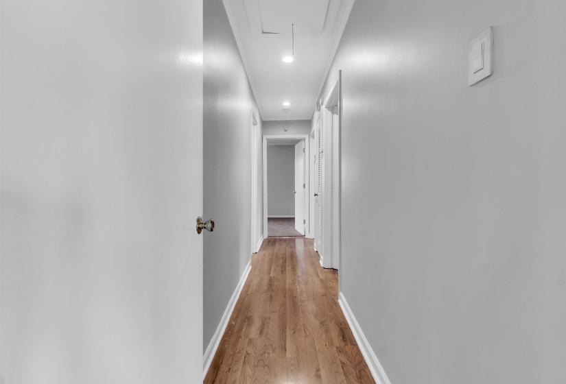 Hall with light wood-style flooring and recessed lighting