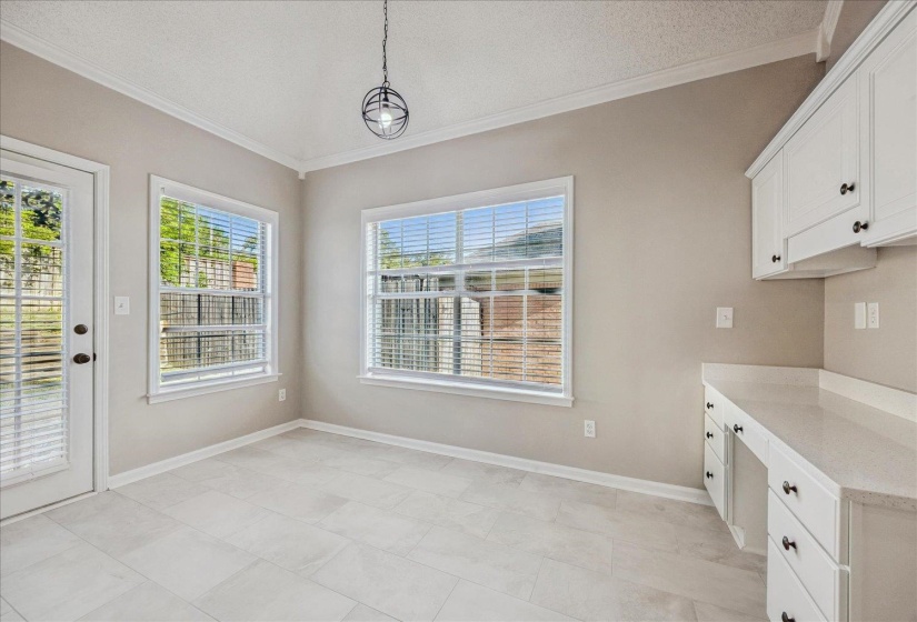Unfurnished dining area with crown molding and a textured ceiling
