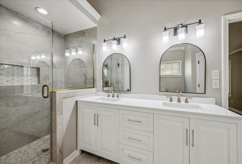 Bathroom with double vanity and a shower stall