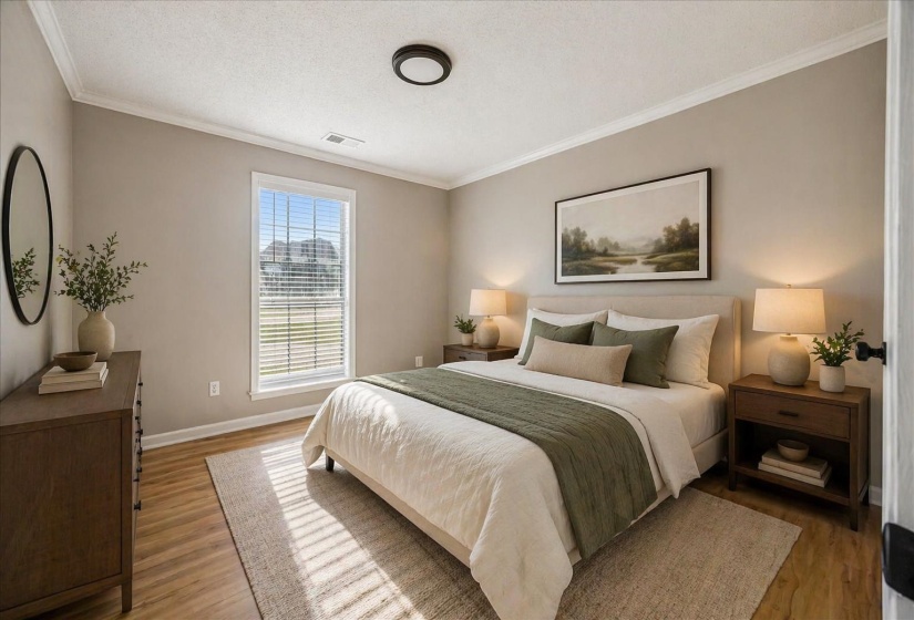 Bedroom featuring ornamental molding, a textured ceiling, and light wood-style floors