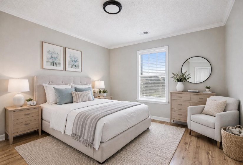Bedroom with light wood-style floors, a textured ceiling, and crown molding