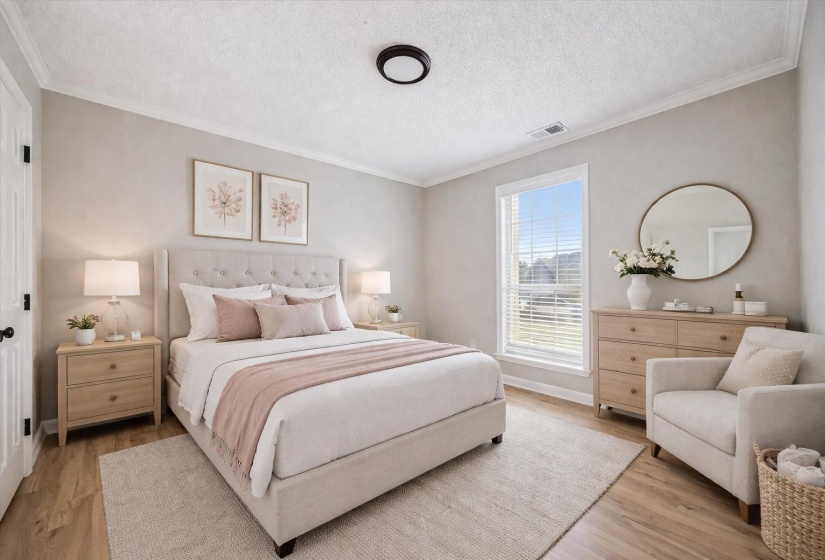 Bedroom with crown molding, a textured ceiling, and light wood finished floors