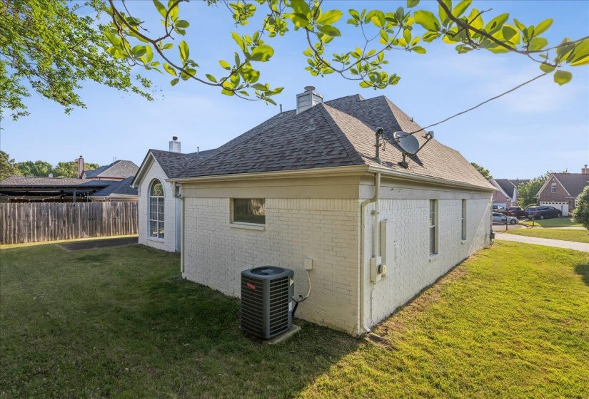 View of home's exterior featuring brick siding, a chimney, and roof with shingles