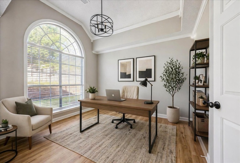 Office with crown molding, lofted ceiling, light wood finished floors, and hanging lights