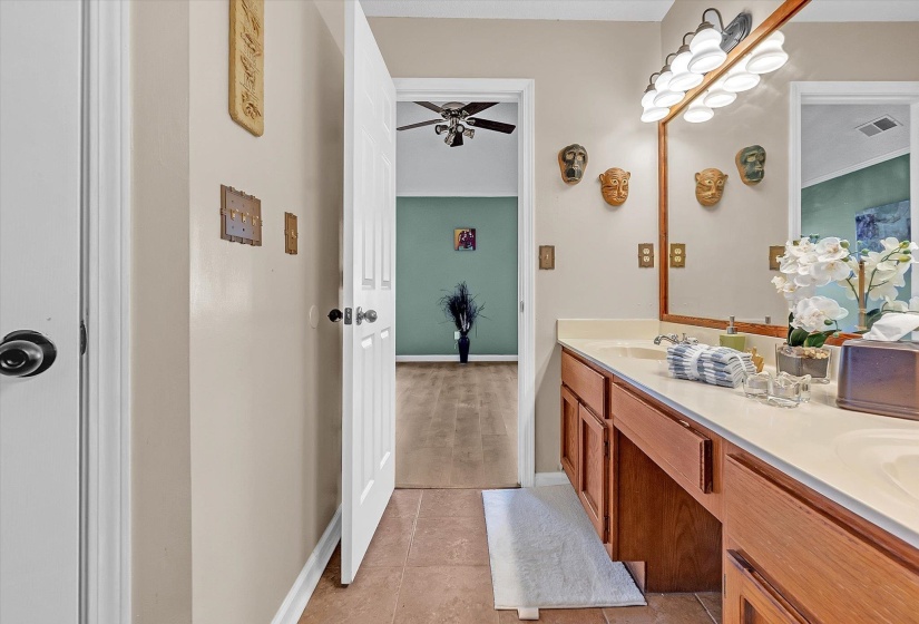 Bathroom with double vanity and light tile patterned flooring