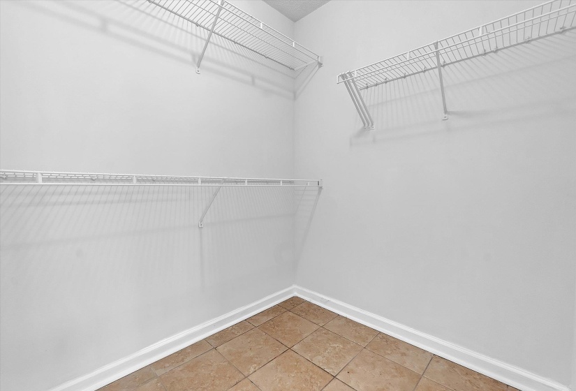 Walk in closet with light tile patterned flooring
