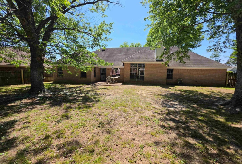 Back of property with a patio area, brick siding, and a fenced backyard