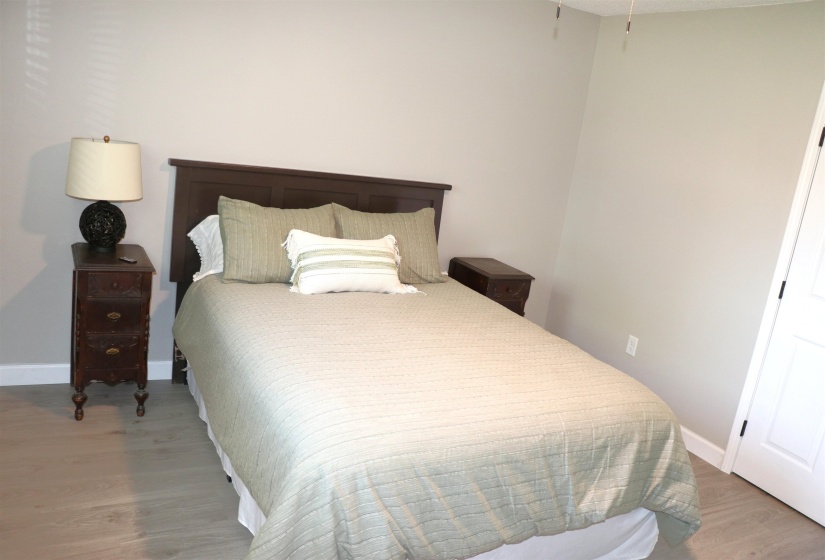Bedroom with light wood-style flooring and baseboards