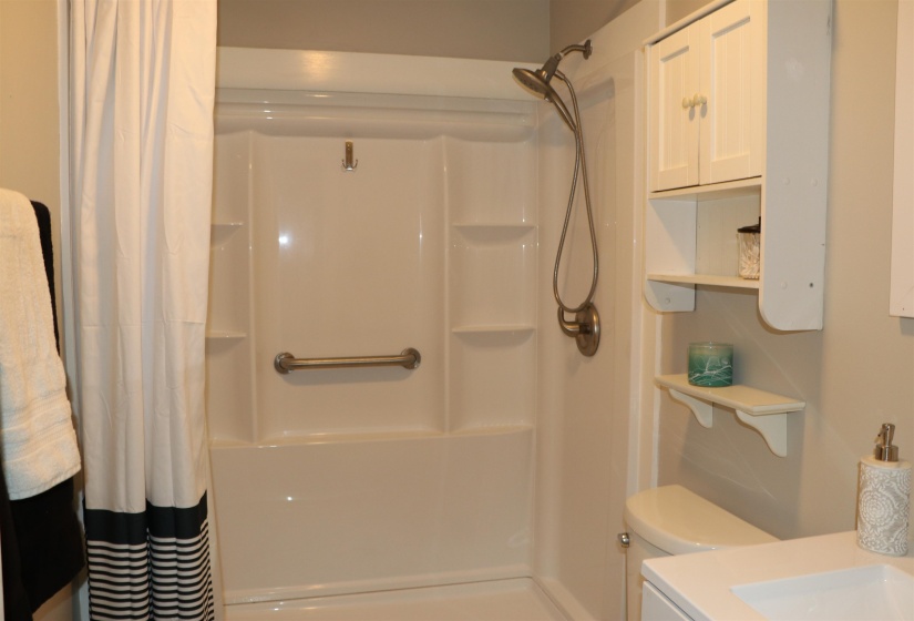 Full bathroom featuring a shower with shower curtain and vanity